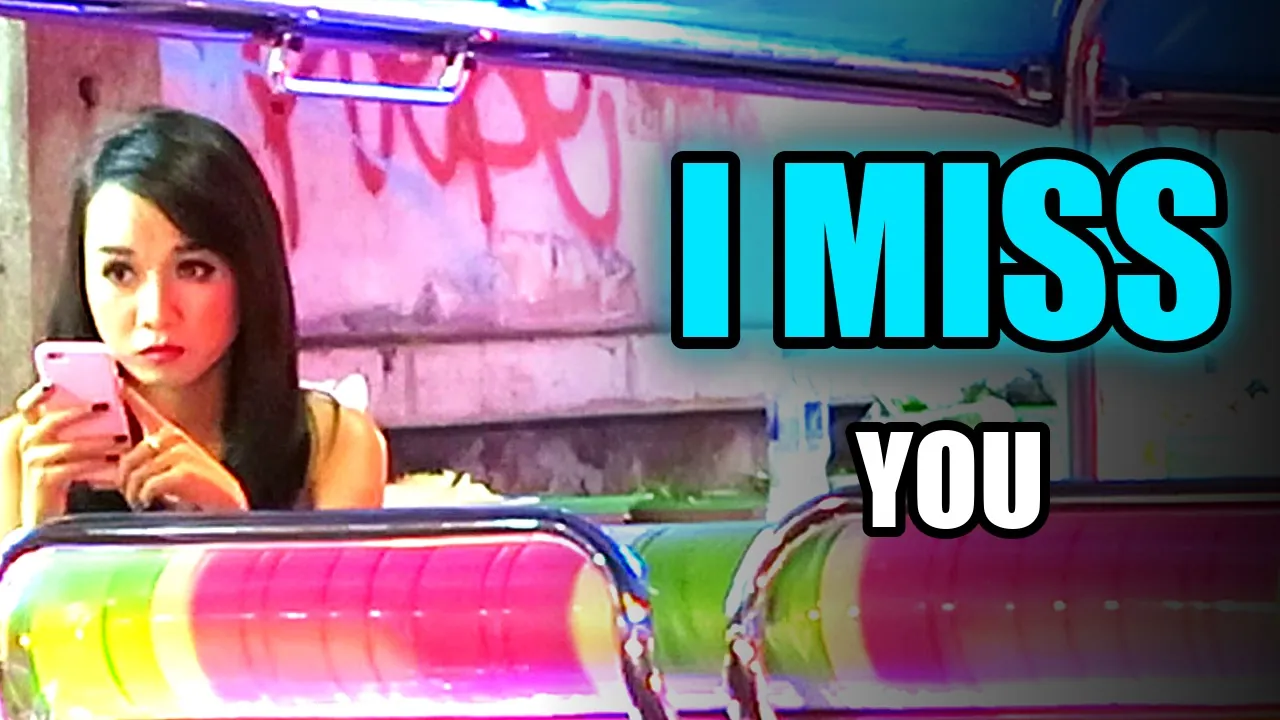 A woman typing on her phone in Thailand, with the words I miss you